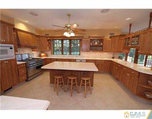 715 Old Raritan Road Edison, NJ 08820 - Photo 7 of 22 a kitchen with stainless steel appliances granite countertop a sink and a refrigerator