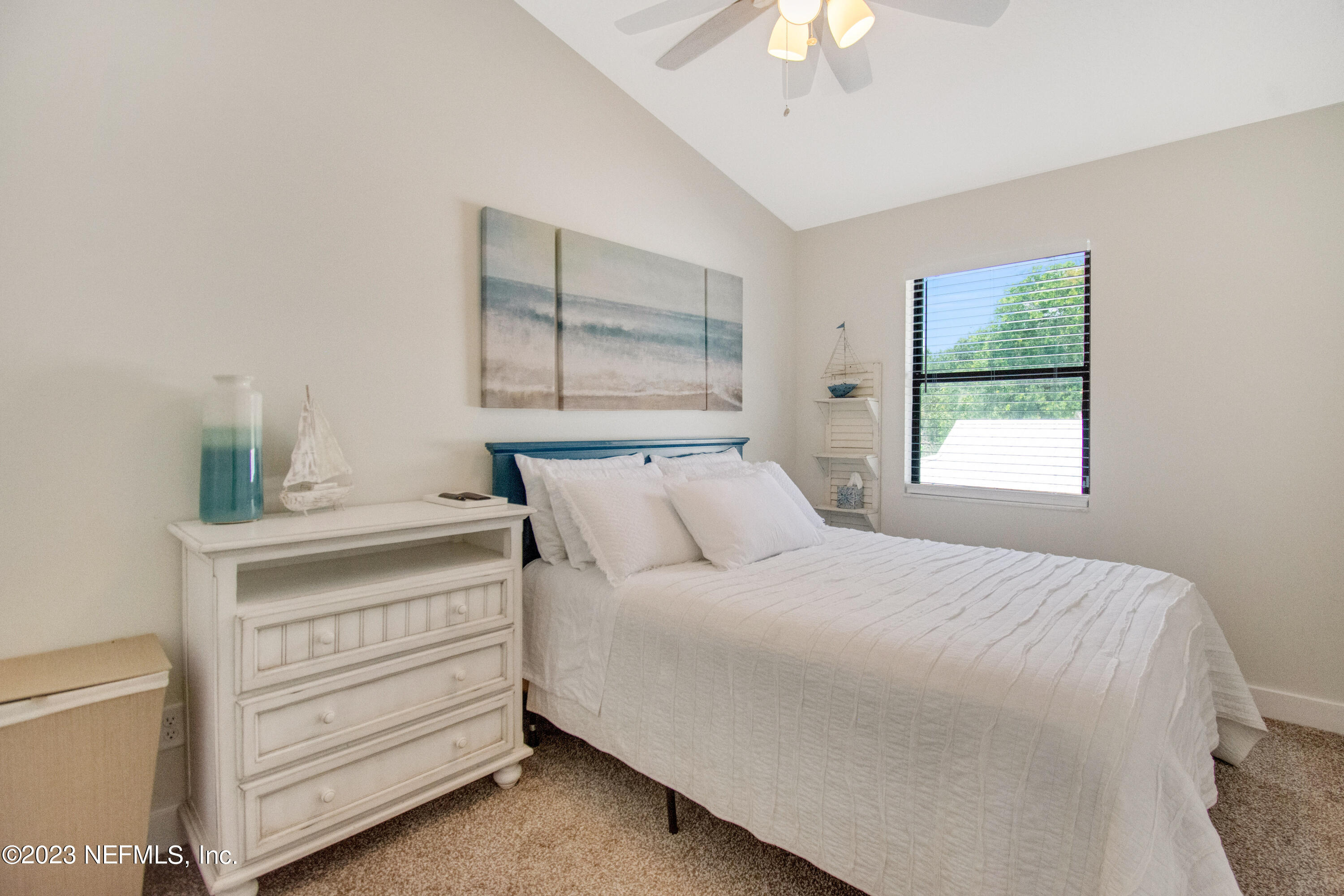 5378 A1A South St. Augustine, FL 32080 - Photo 22 of 34 a bedroom with a bed and a chandelier