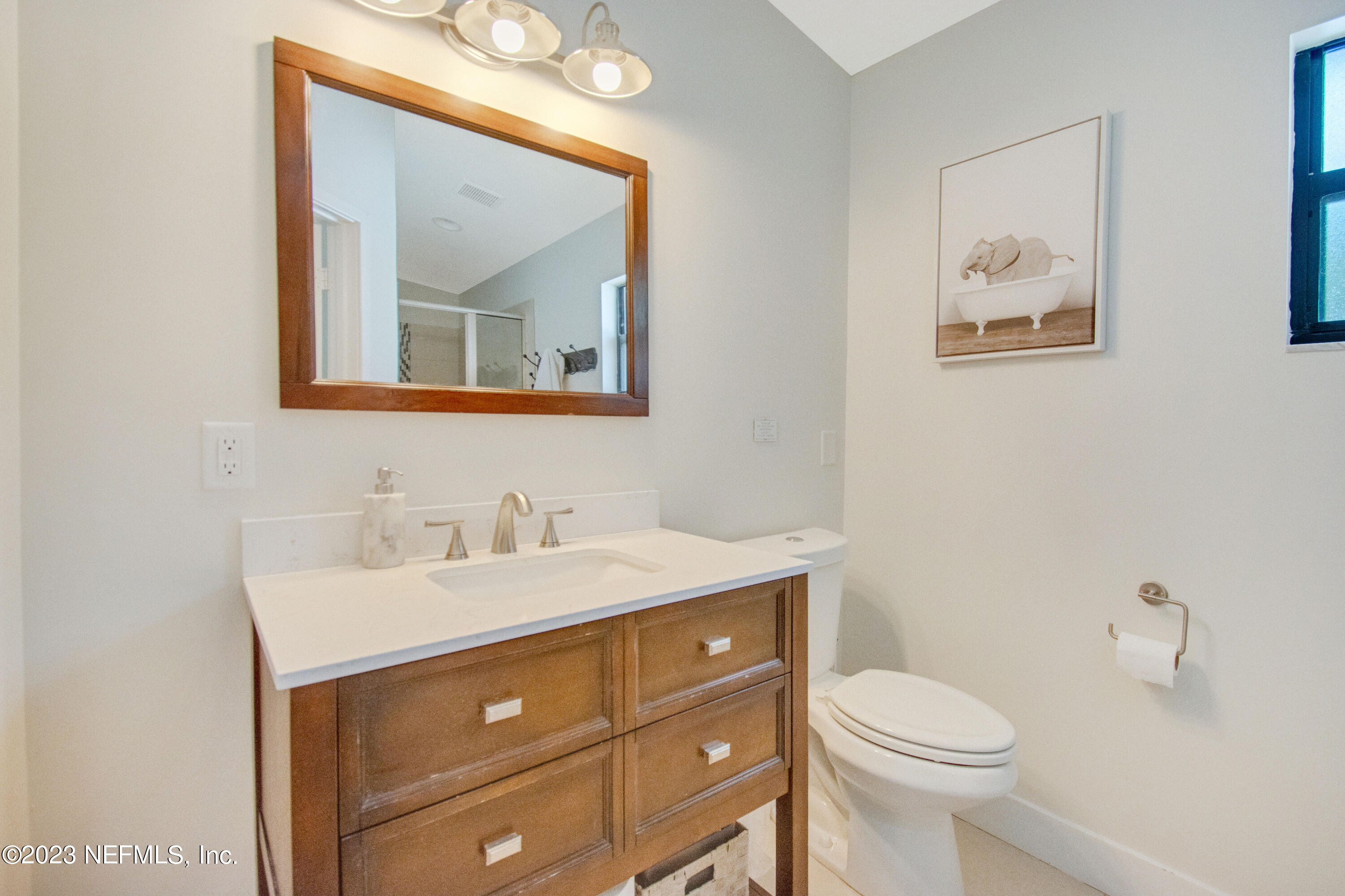 5378 A1A South St. Augustine, FL 32080 - Photo 24 of 34 a bathroom with a toilet a sink and mirror