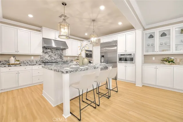 a kitchen with stainless steel appliances granite countertop a stove oven and a refrigerator