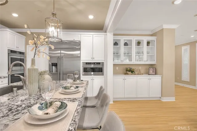 a kitchen with kitchen island granite countertop a sink a center island and cabinets