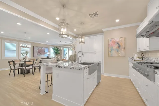 a kitchen with granite countertop white cabinets and stainless steel appliances