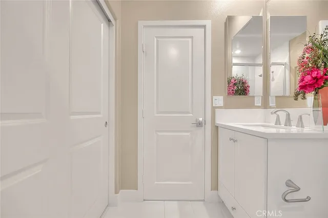 a view of a room with a large window and front door