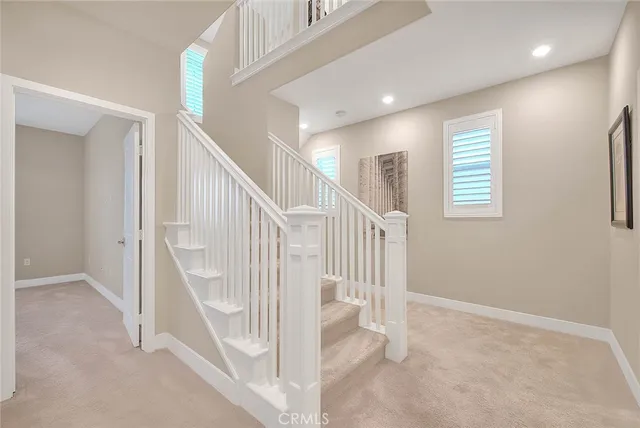a bathroom with white cabinets and sink