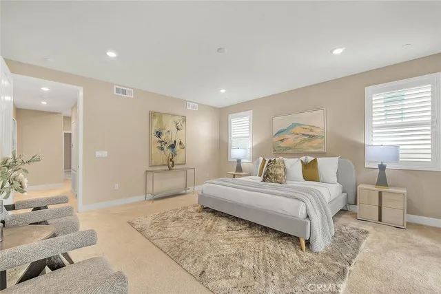 a spacious bathroom with a granite countertop sink and a mirror