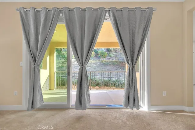 an empty room with window and mirror