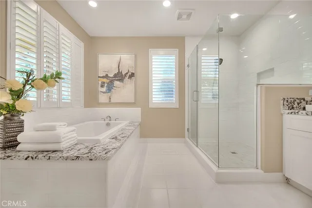 a view of an empty room with closet and a window