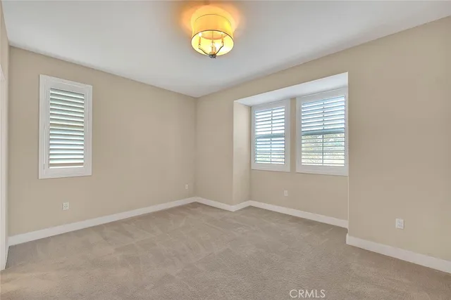 a room with pool table and windows