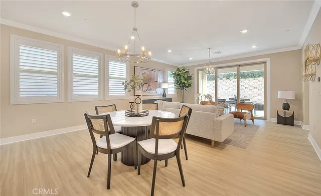a dining room with wooden floor and breakfast area