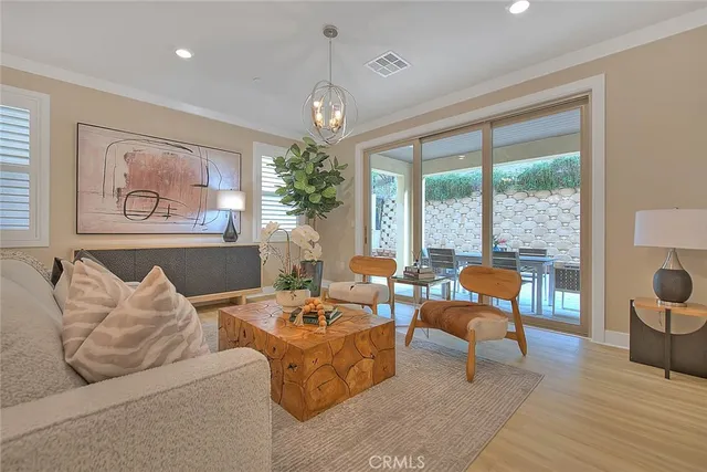 a kitchen with stainless steel appliances granite countertop a stove a refrigerator a sink dishwasher and white cabinets with wooden floor