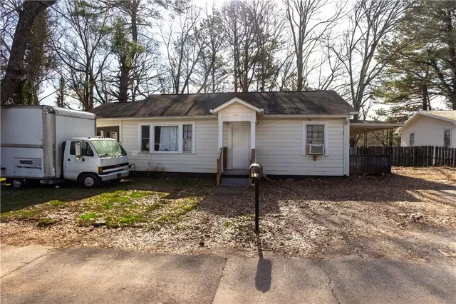 a view of a house with a yard covered in snow
