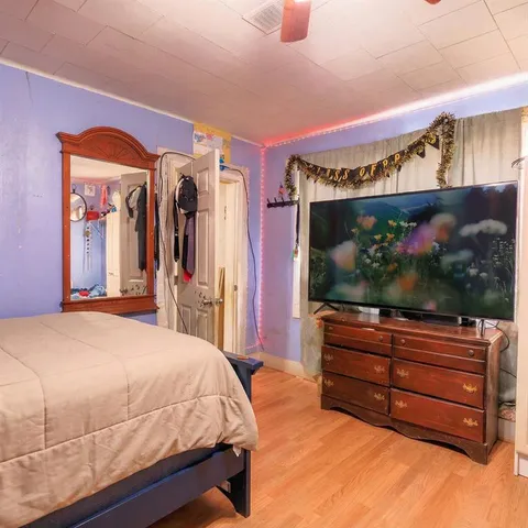 a bedroom with a bed and a flat screen tv