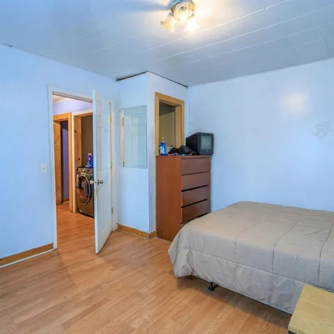 a bedroom with a bed and a mirror