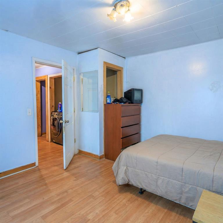 241 East Killian Street Canton, GA 30114 - Photo 13 of 15 a bedroom with a bed and a mirror