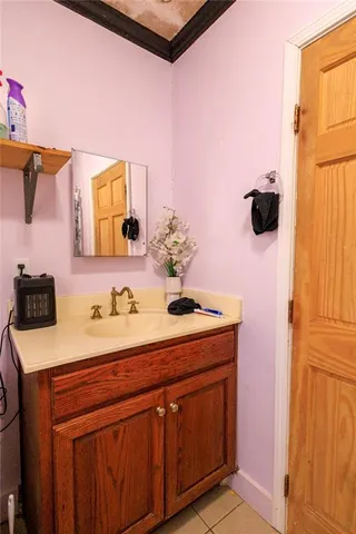 a bathroom with a sink vanity and mirror