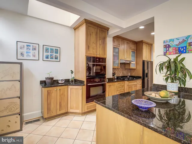 a kitchen with stainless steel appliances a stove a sink and a refrigerator