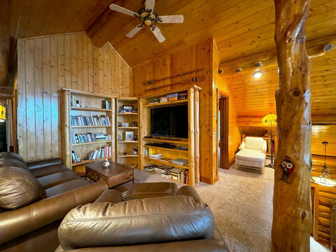 7236 Far North Road Orr, MN 55771 - Photo 17 of 42 Living room featuring wooden walls, carpet, ceiling fan, and wood ceiling