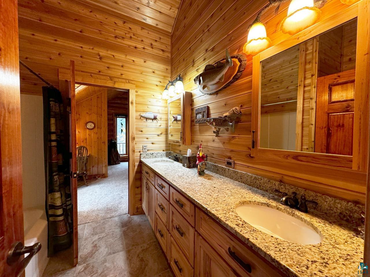 7236 Far North Road Orr, MN 55771 - Photo 18 of 42 Full bathroom with wood walls, double vanity, and wood ceiling