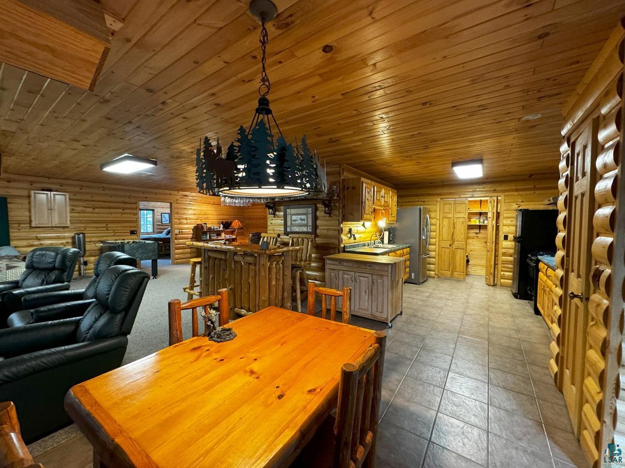7236 Far North Road Orr, MN 55771 - Photo 24 of 42 Dining room with log walls and wooden ceiling