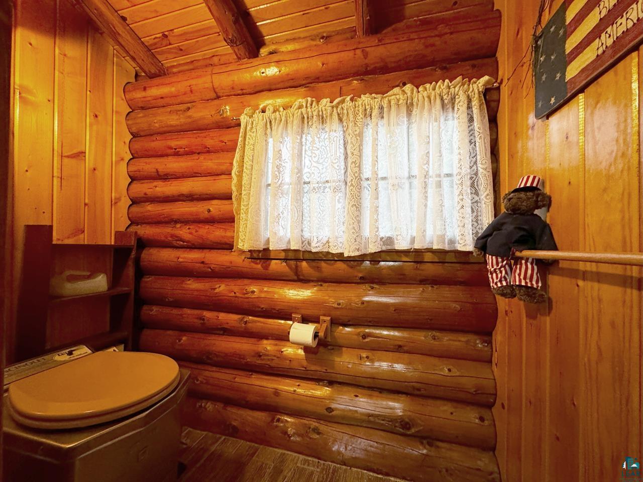 7236 Far North Road Orr, MN 55771 - Photo 40 of 42 Bathroom with wood finished floors, log walls, and wood ceiling