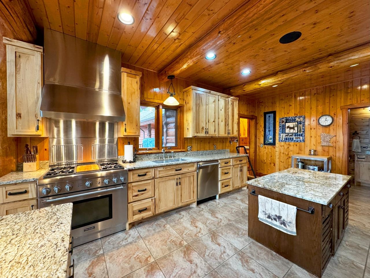 7236 Far North Road Orr, MN 55771 - Photo 6 of 42 Kitchen with appliances with stainless steel finishes, wall chimney exhaust hood, a sink, wood ceiling, and recessed lighting