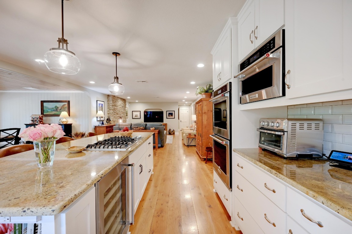 1020 River Road Wimberley, TX 78676 - Photo 40 of 40 a kitchen with stainless steel appliances granite countertop a sink and a stove