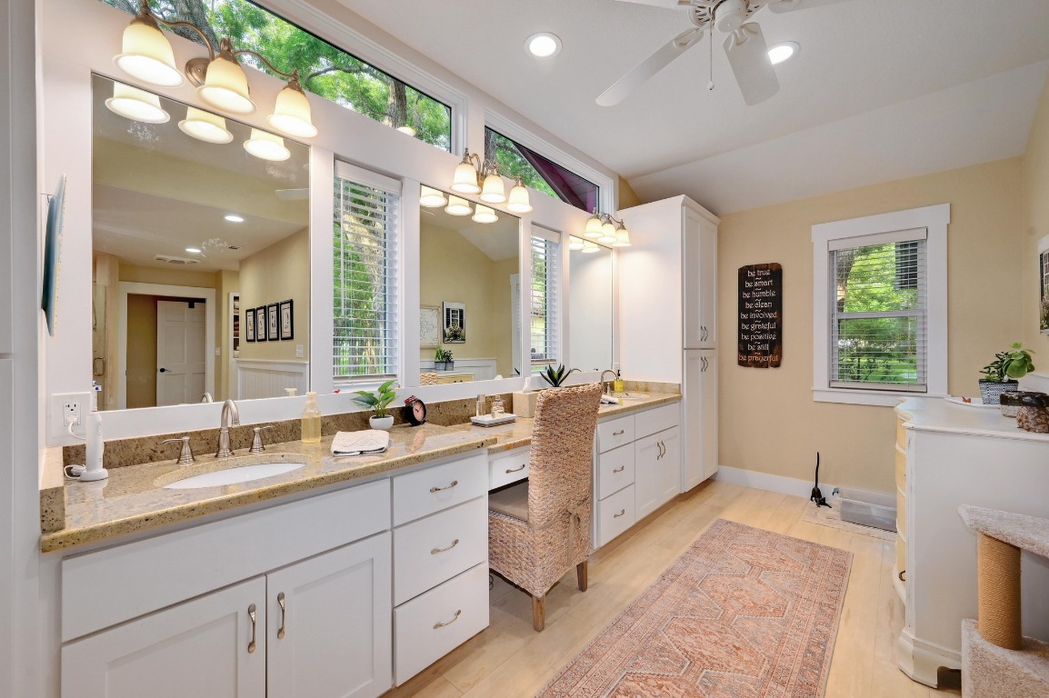 1020 River Road Wimberley, TX 78676 - Photo 22 of 40 a large bathroom with a large mirror vanity and a sink