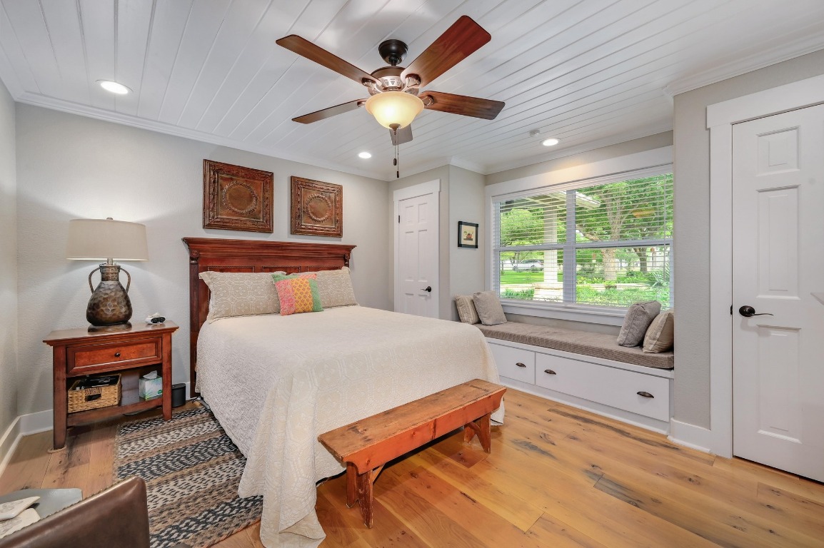 1020 River Road Wimberley, TX 78676 - Photo 24 of 40 a bedroom with a large bed and a large window