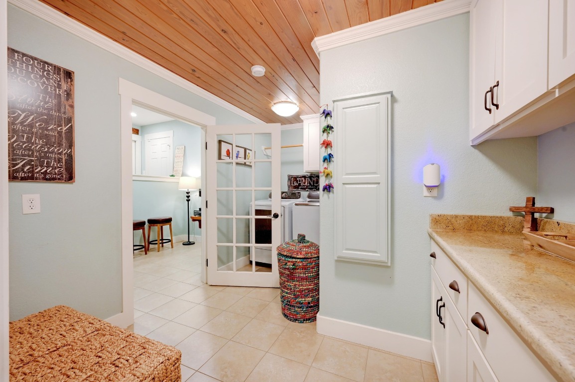 1020 River Road Wimberley, TX 78676 - Photo 26 of 40 a kitchen with a refrigerator and cabinets