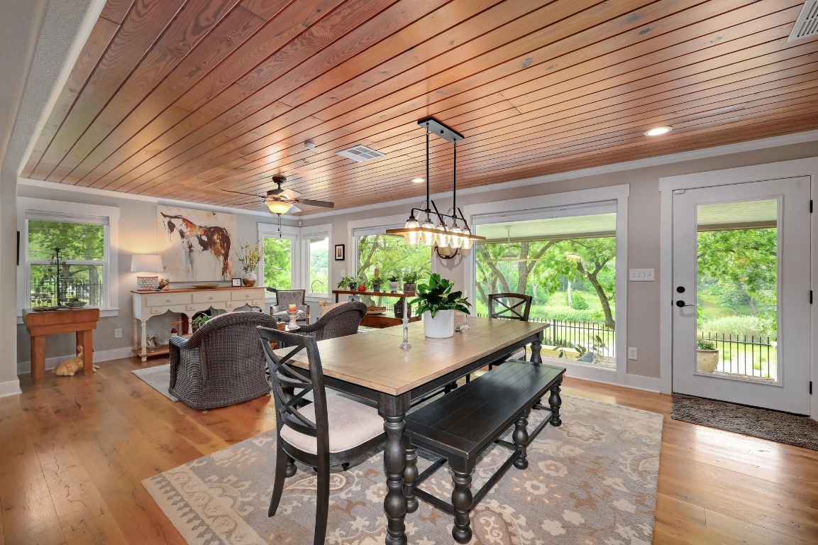 1020 River Road Wimberley, TX 78676 - Photo 4 of 40 a view of a dining room with furniture window and wooden floor