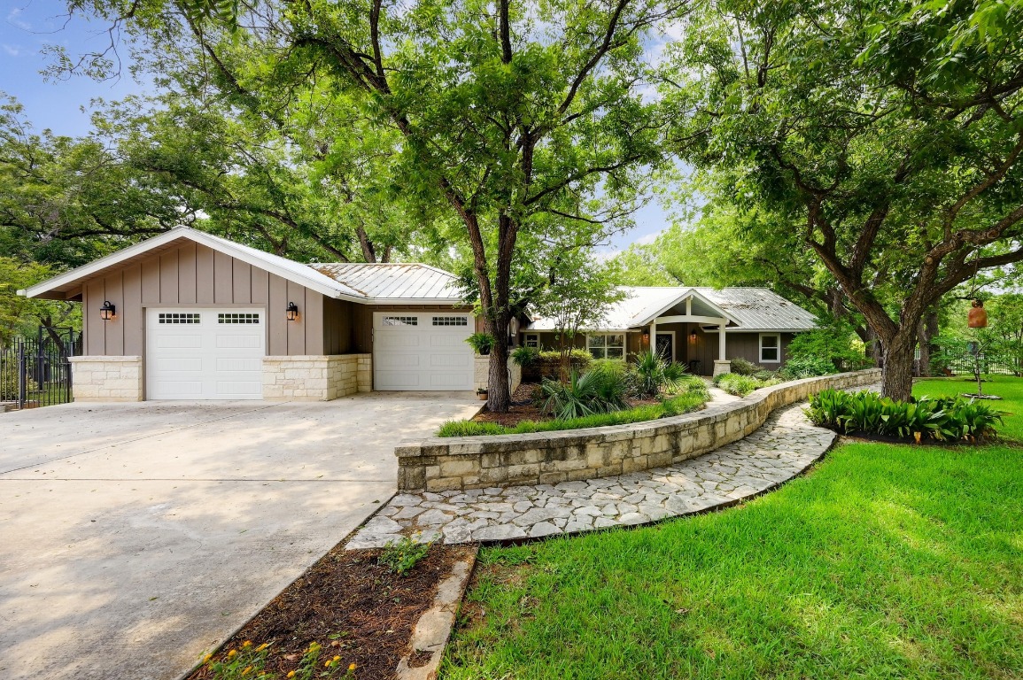 1020 River Road Wimberley, TX 78676 - Photo 7 of 40 a front view of a house with a yard