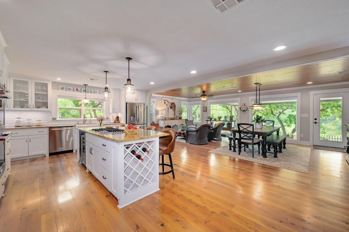 1020 River Road Wimberley, TX 78676 - Photo 9 of 40 a kitchen with lots of counter top space and dining table