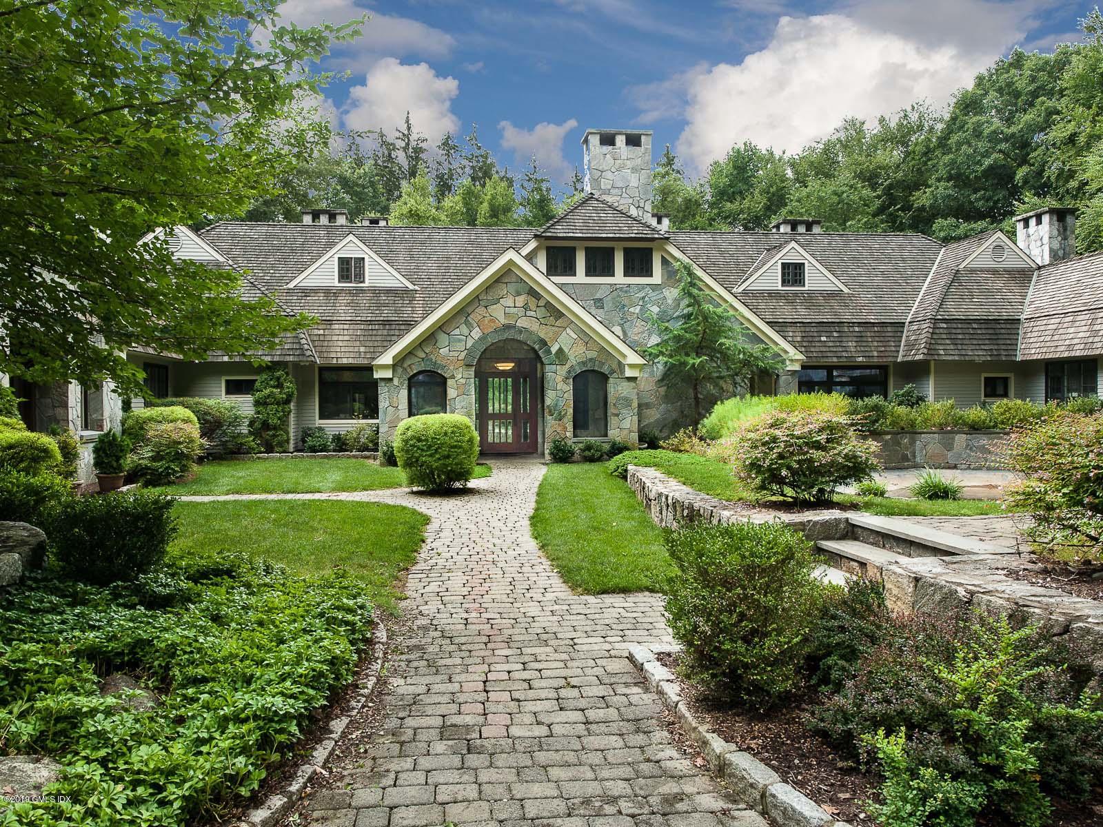 17 Heronvue Road Greenwich, CT 06831 - Photo 1 of 31 a front view of a house with a yard and potted plants