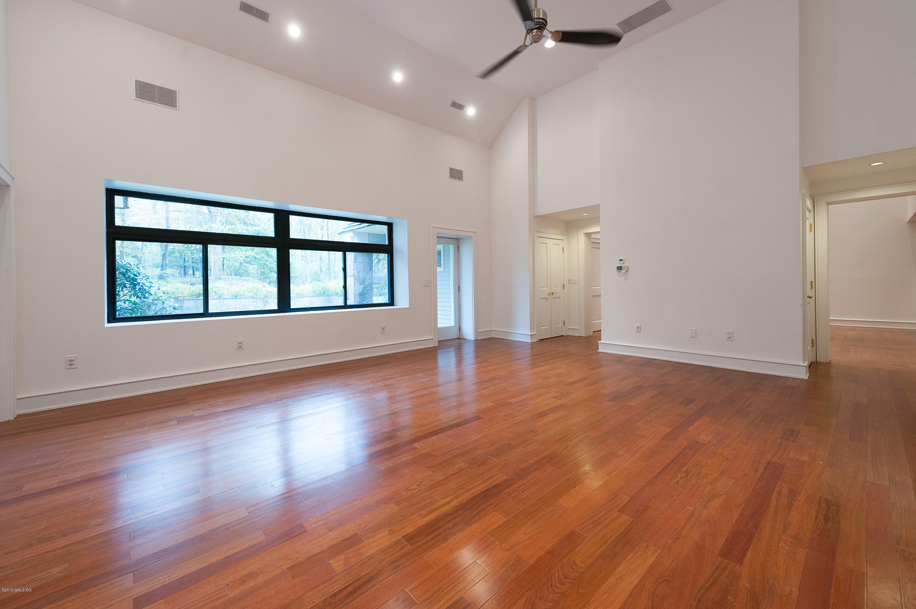 17 Heronvue Road Greenwich, CT 06831 - Photo 11 of 31 an empty room with wooden floor and windows
