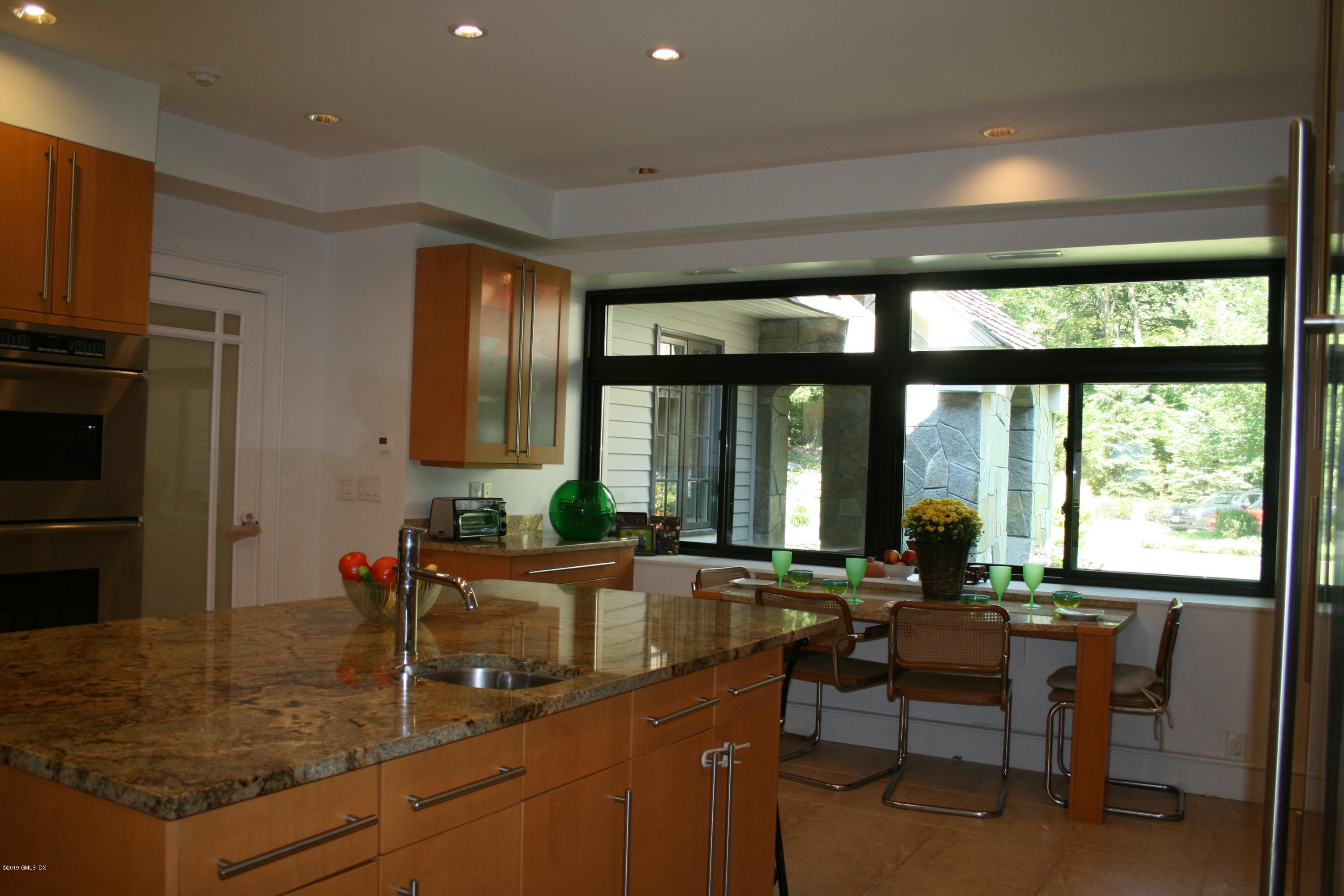 17 Heronvue Road Greenwich, CT 06831 - Photo 15 of 31 a kitchen with kitchen island granite countertop a sink and a refrigerator
