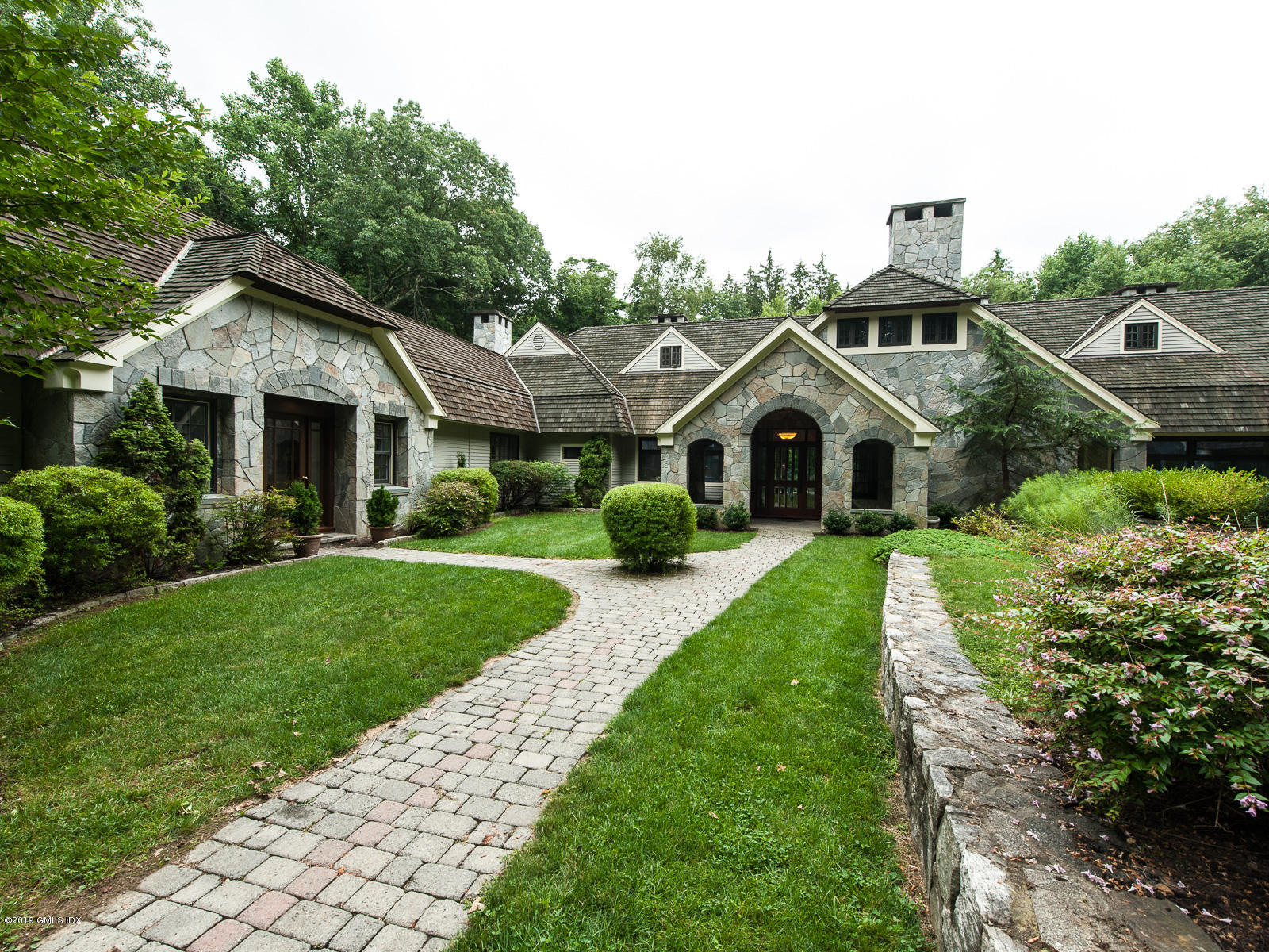 17 Heronvue Road Greenwich, CT 06831 - Photo 21 of 31 a front view of a house with a garden and plants