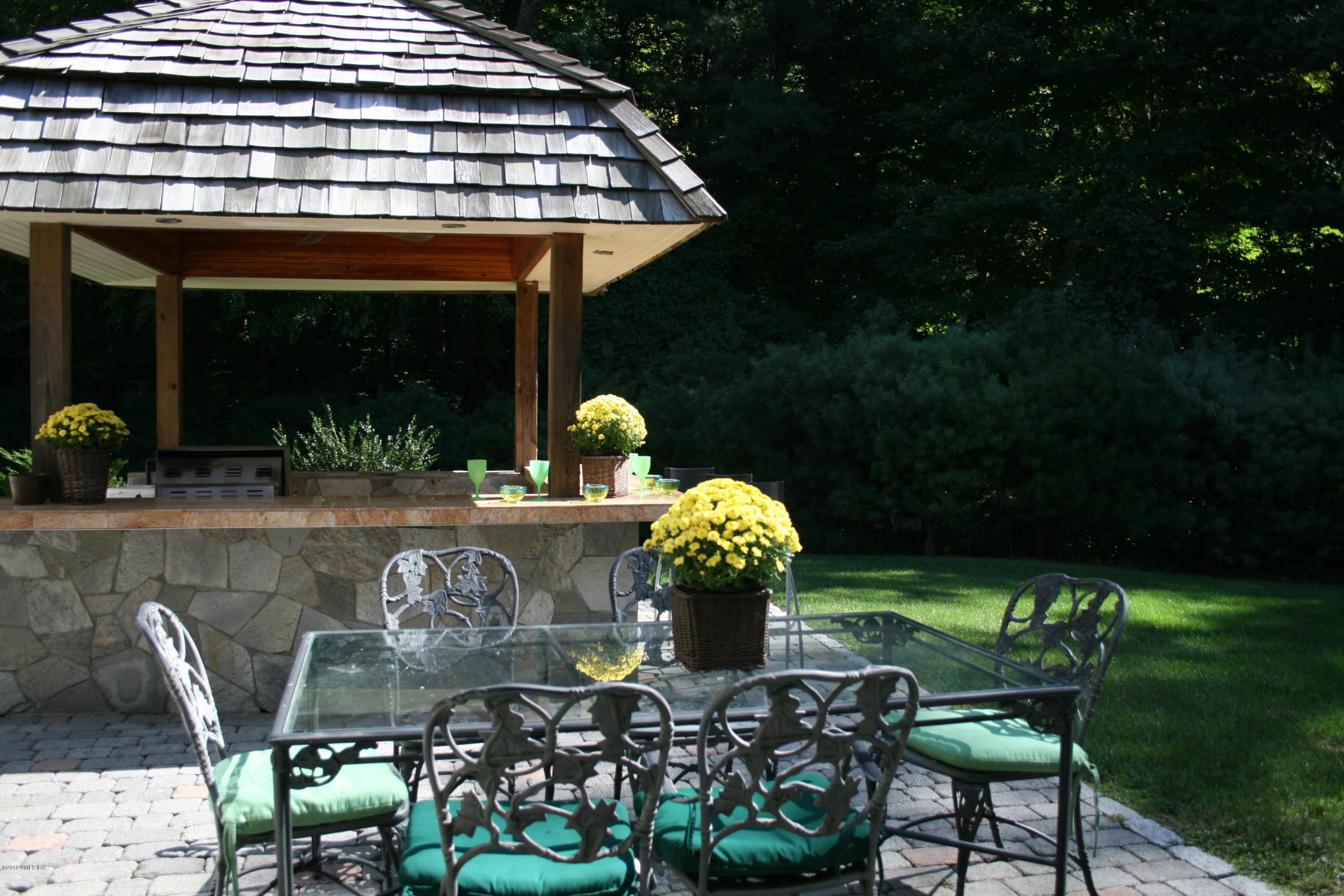17 Heronvue Road Greenwich, CT 06831 - Photo 25 of 31 a front view of a house with outdoor seating