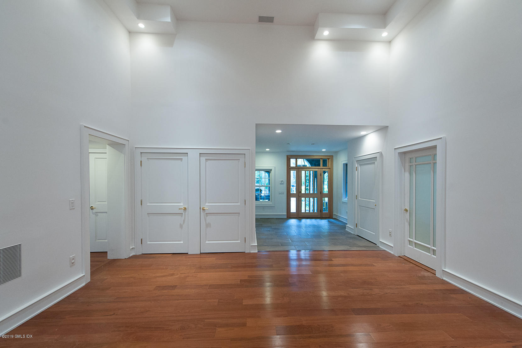 17 Heronvue Road Greenwich, CT 06831 - Photo 3 of 31 an empty room with wooden floor and windows