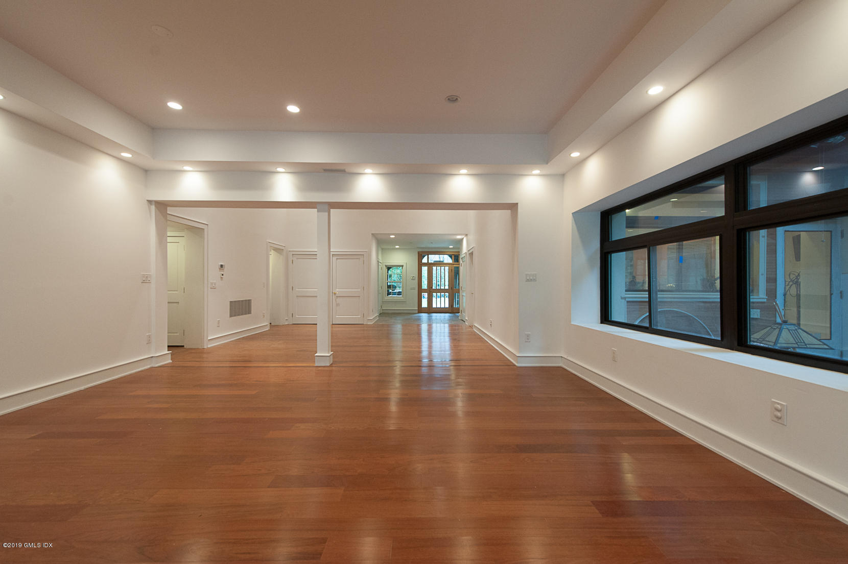 17 Heronvue Road Greenwich, CT 06831 - Photo 7 of 31 a view of an empty room with wooden floor and a window