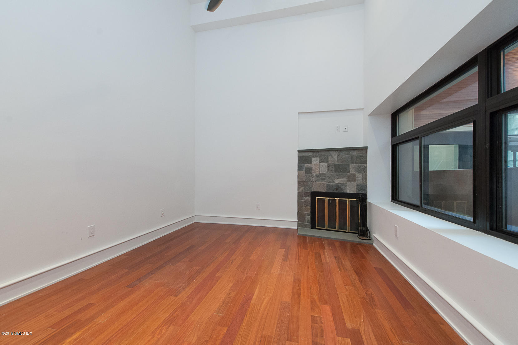 17 Heronvue Road Greenwich, CT 06831 - Photo 9 of 31 a view of a room with wooden floor and a fireplace