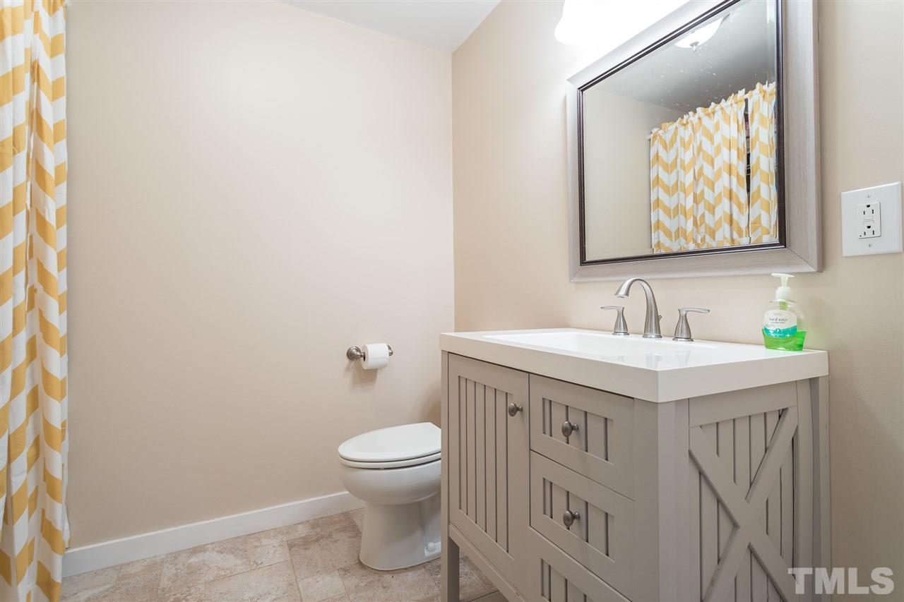 7535 Mine Valley Road Raleigh, NC 27615 - Photo 12 of 26 a bathroom with a sink a toilet and mirror