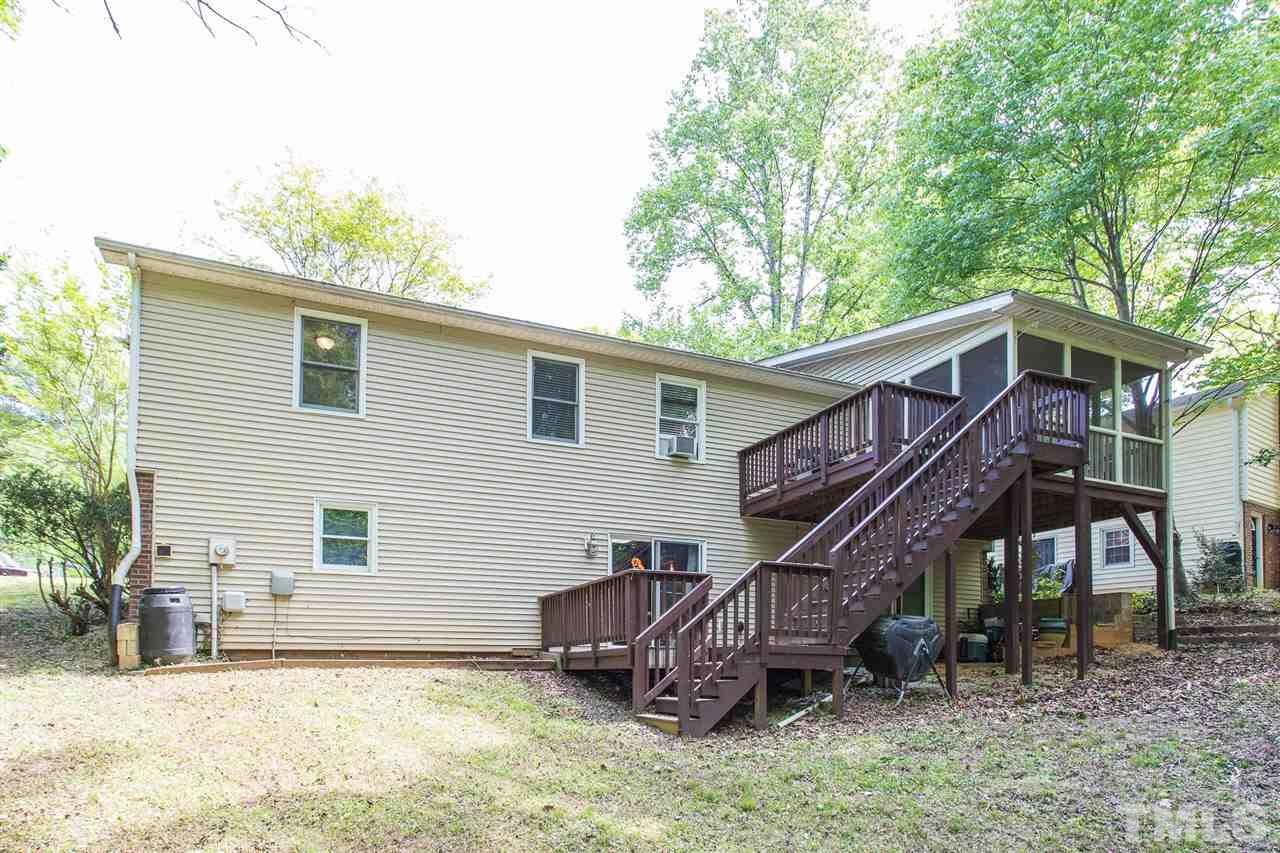 7535 Mine Valley Road Raleigh, NC 27615 - Photo 17 of 26 a backyard of a house with wooden deck and barbeque oven