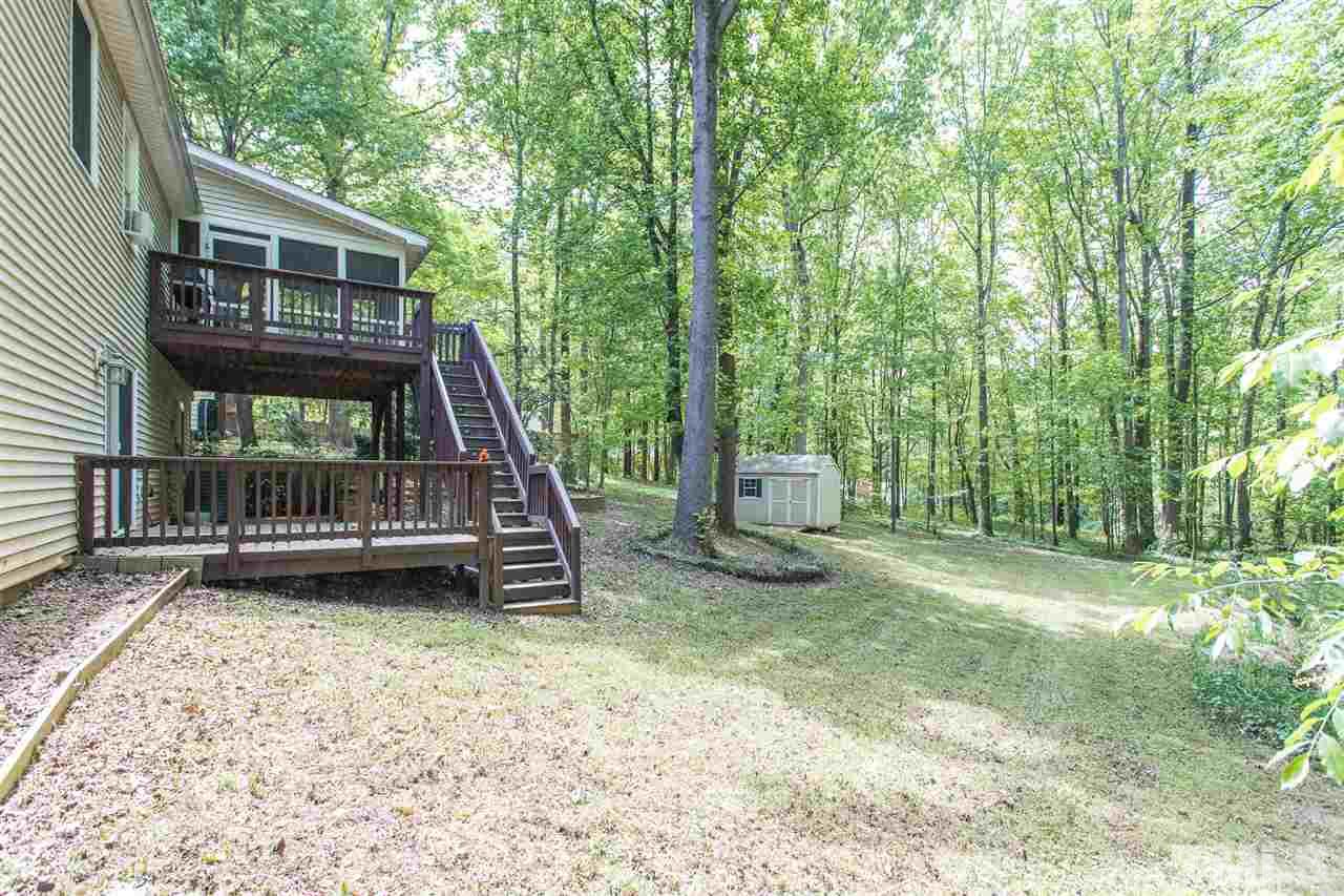 7535 Mine Valley Road Raleigh, NC 27615 - Photo 18 of 26 a view of a house with a backyard and a patio