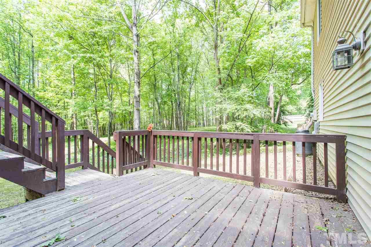 7535 Mine Valley Road Raleigh, NC 27615 - Photo 20 of 26 a balcony with wooden floor and fence