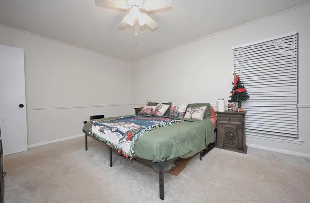a bed room with a bed mirror and a chandelier
