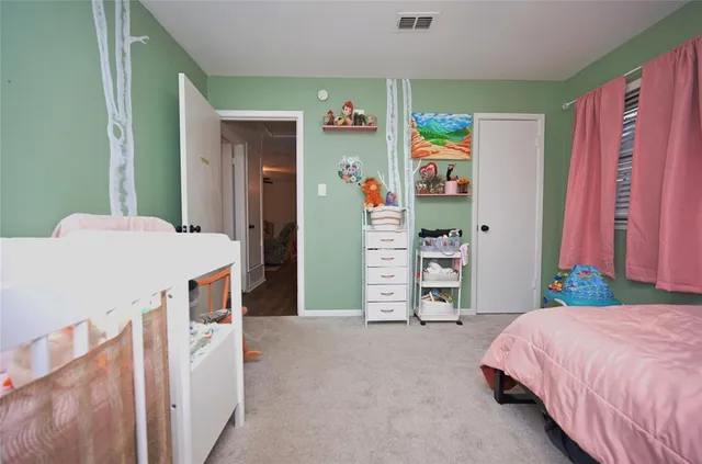 a bedroom with a bed and a chair