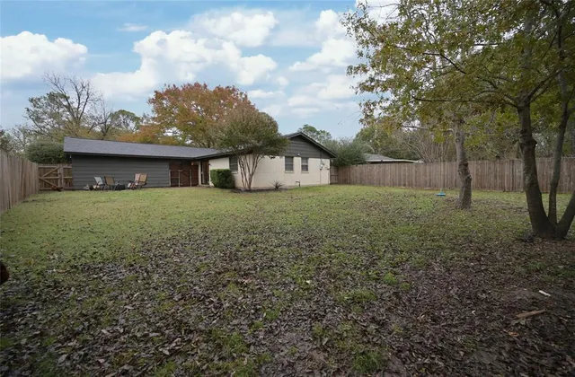 a backyard of a house with table and chairs