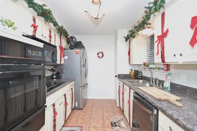 a kitchen with kitchen island granite countertop a sink a counter space and cabinets