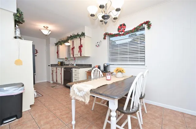a dining room with furniture and a chandelier