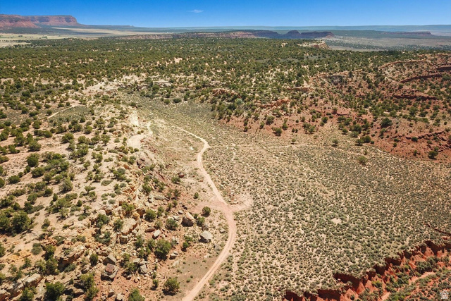 5615 East Eight Mile Gap Road Kanab, UT 84741 - Photo 63 of 81 Aerial view of sparsely populated area featuring a mountain backdrop and a desert landscape